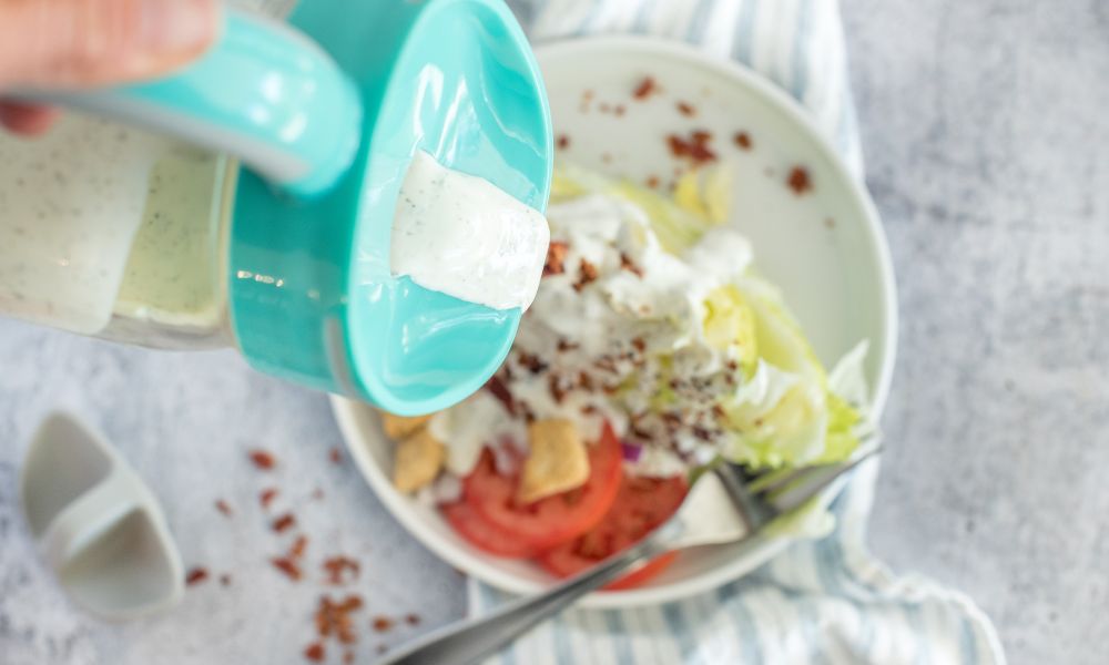 Buttermilk ranch salad dressing pouring from a mason jar with an Ergo Spout WIDE.