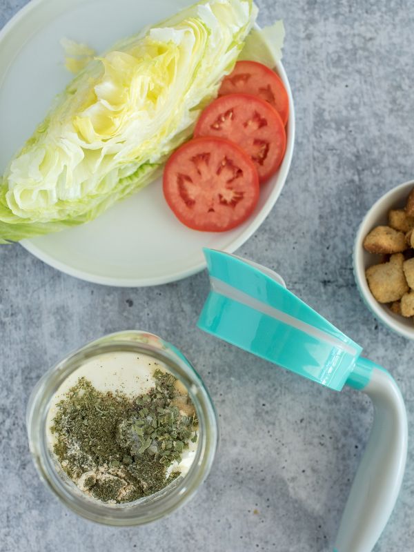 Layout with mason jar of salad dressing, Ergo Spout WIDE, and salad makings