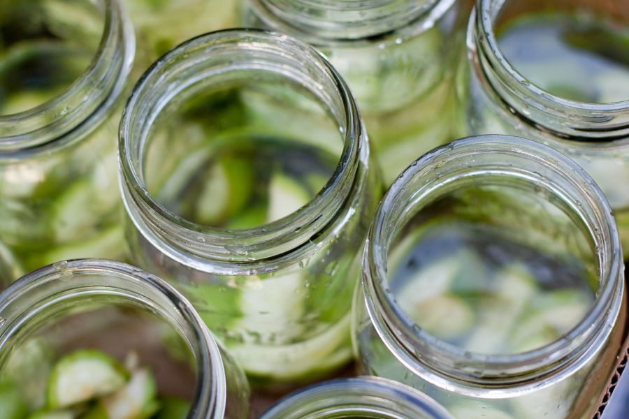 Mason jars with no lid and something green in the bottom.