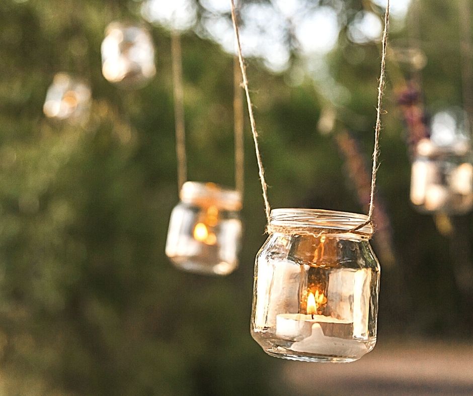 Candles in mason jars handing from string
