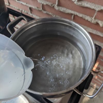 Water pouring into bottom of steam juicer