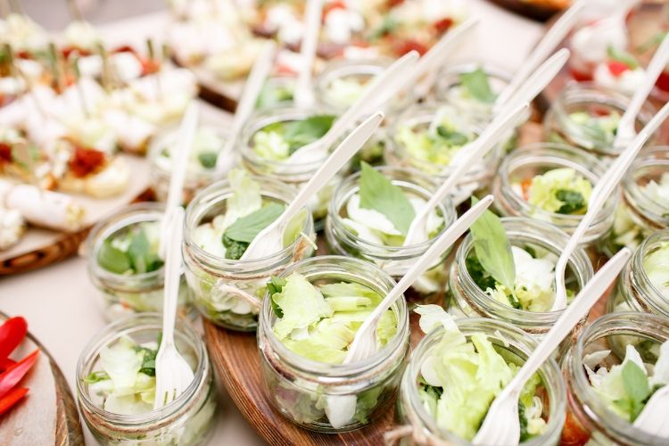 Small mason jars with salads and forks