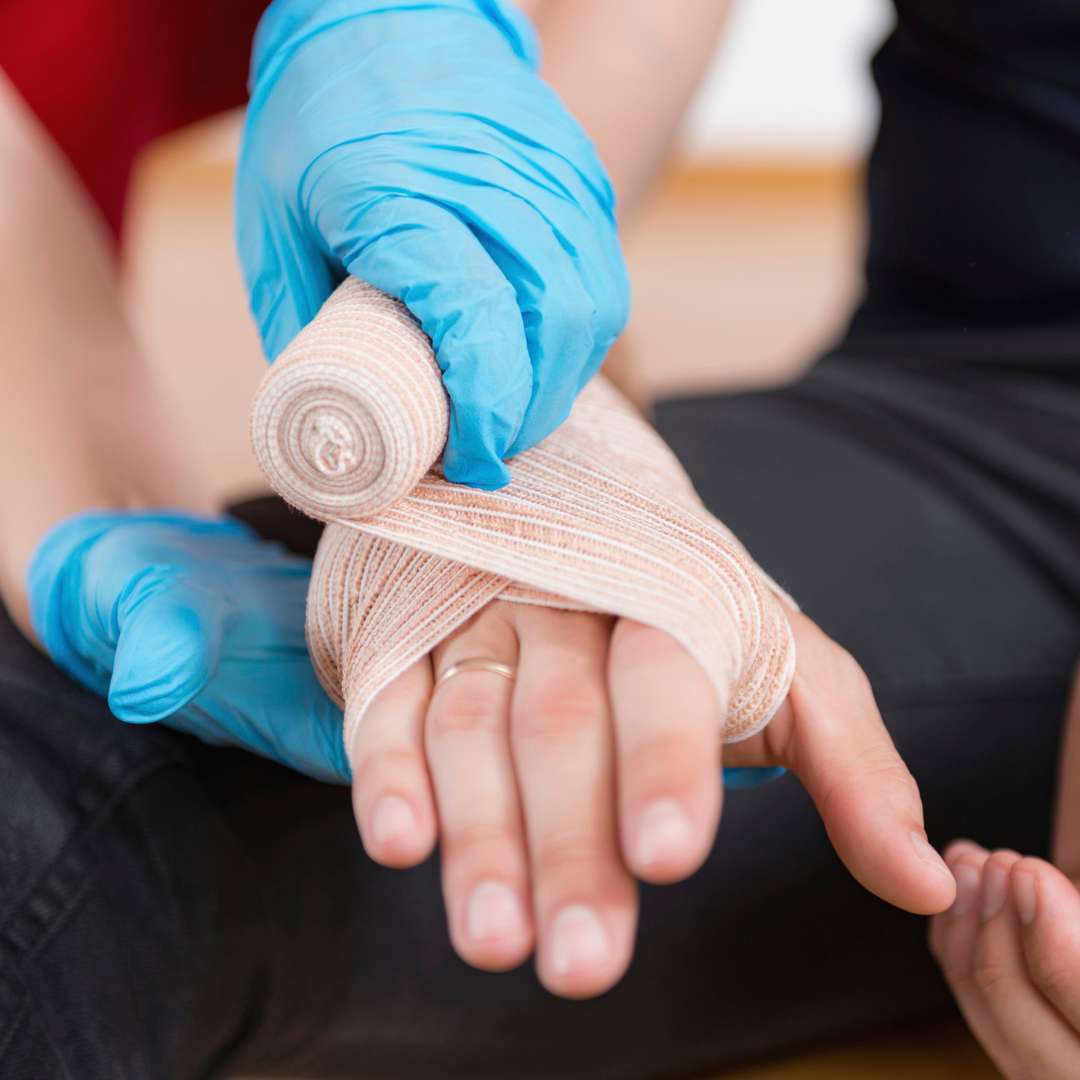 applying bandage to hand