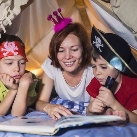 Kids reading under a tent
