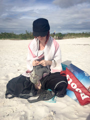 Knit Me owner Kelsi knitting on the beach