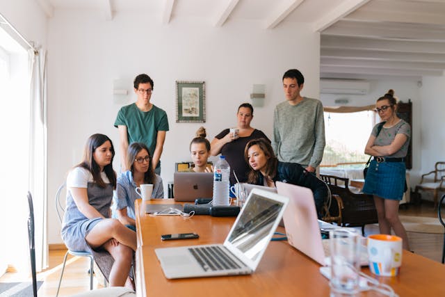 students gathered around working a job