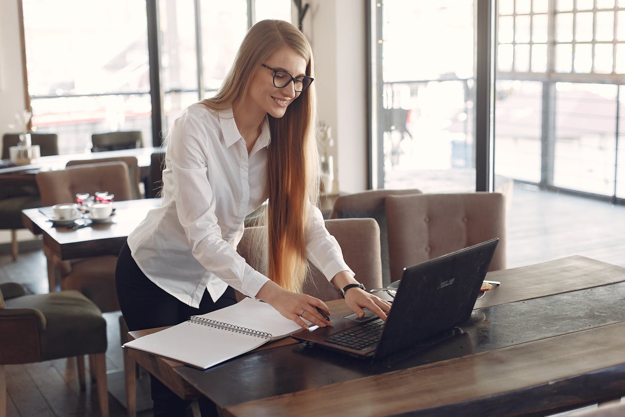 The Art of Resume | Woman Standing and Typing at Computer