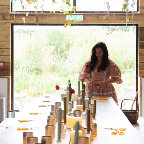 Sophie from Sophie Flowers at the head of the candle and St. Eval tin covered table, preparing for the workshop