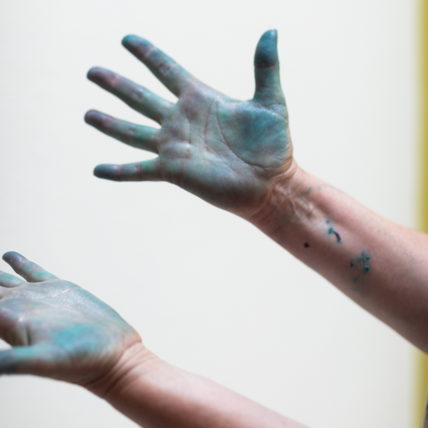 Image of blue stained hands from paper making at The Tate St. Ives's creative workshop