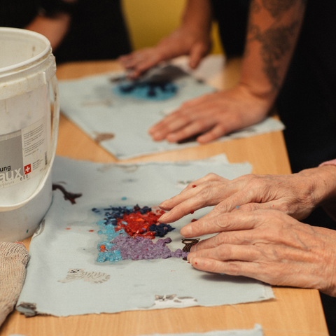 Image of patient creating paper using pulp