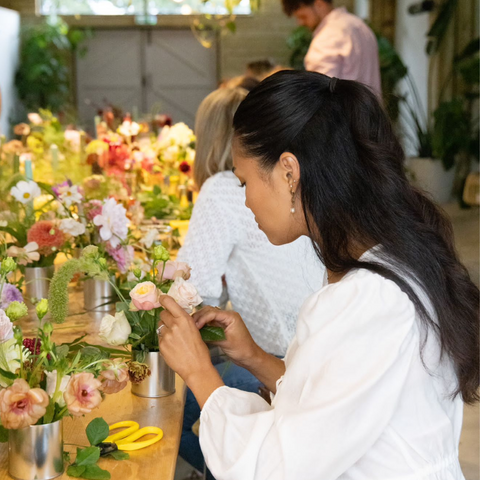 Flower workshop attendee arranging their flowers