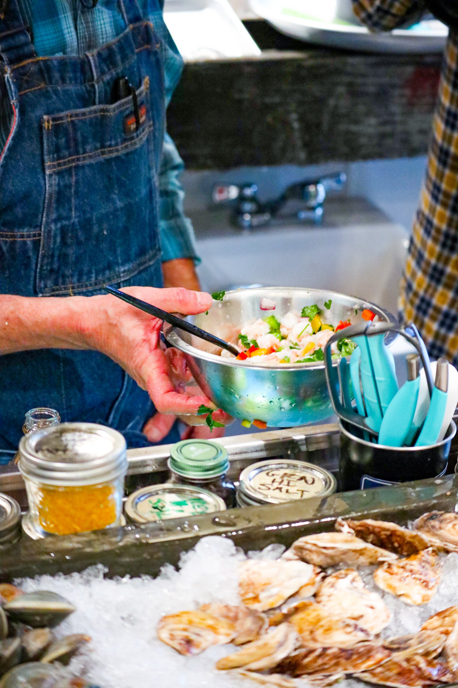 Chef holding mixing bowl filled with Shrimp Ceviche