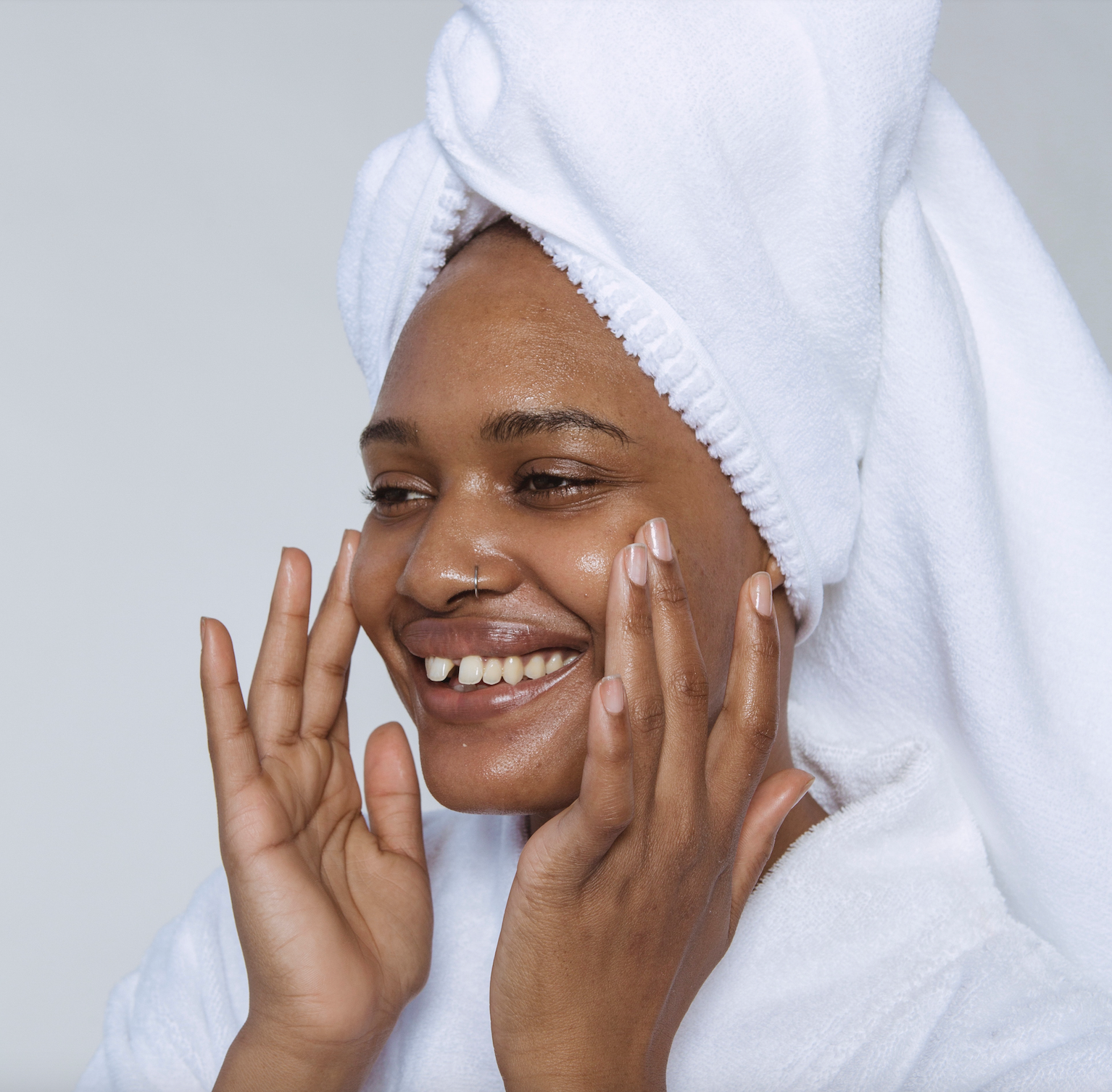 Woman in bath robe and towel on head in the bathroom