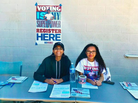 Voter registration table featuring Emmie-X from Calexit, created by Matt Pizzolo, Carlos Granda, and Lauren Affe. Illustration by Emily Pearson