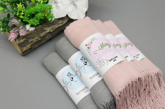 gray and pink scarves with a “stay warm” tag