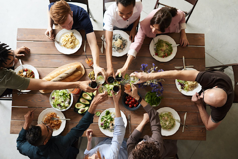 people toasting around a dinner table