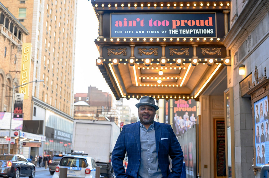 Photo of Clayton Craddock outside the theater of Ain't Too Proud.