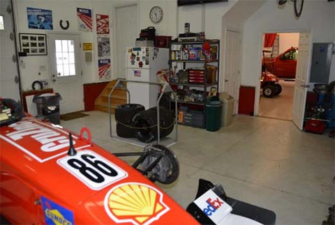 race car in garage with attic lift