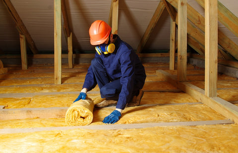 man insulating attic