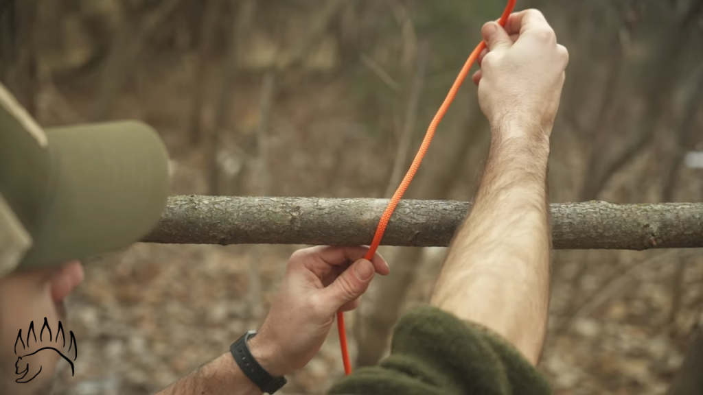 The first step is to wrap the rope around your object, which can be a pole or a stick