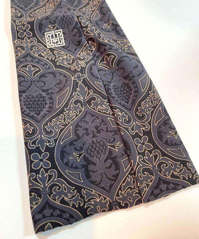 Heliades Sun Protective Clothing UV Arm Sleeves in Black, Gray, Gold all over print and made of UPF 50 patterned fabric.