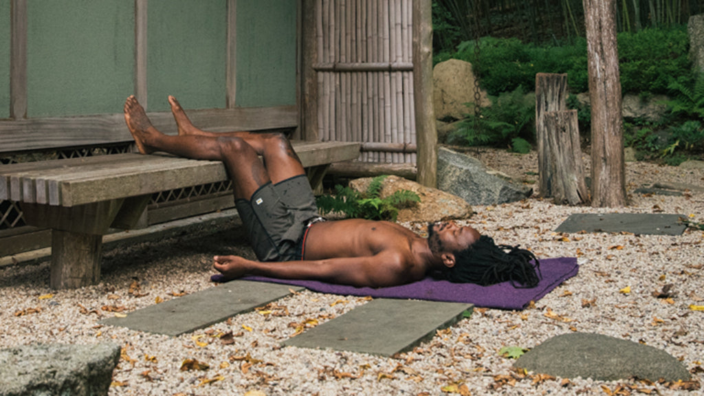 Yoga Instructor Wearing Vuori Banks Shorts in Oregano Splatter in Legs On A Chair Pose