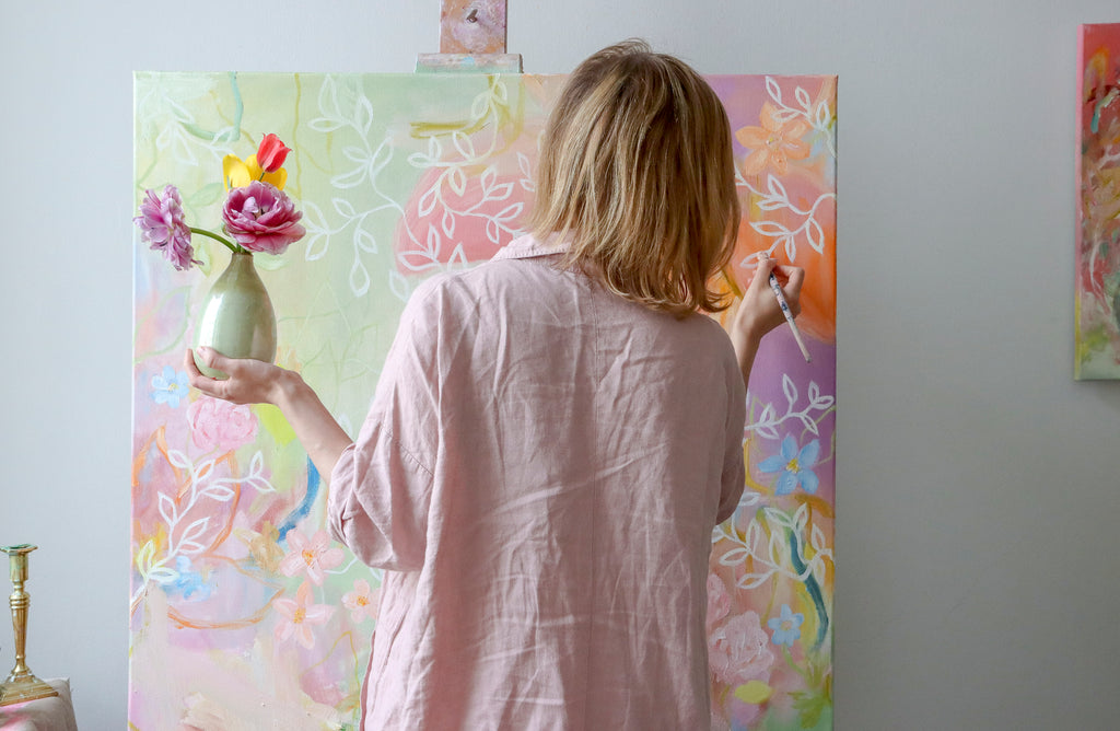 Abstract artist Sanni Olasvuori working in her studio on an abstract floral painting 
