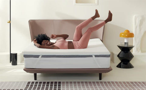 Woman lying back & enjoying Bedsure's memory foam mattress topper with bamboo charcoal