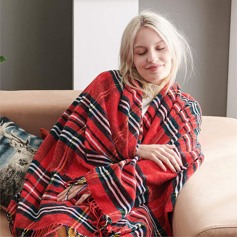 Woman wrapped up & enjoying Bedsure Christmas Plaid Blanket