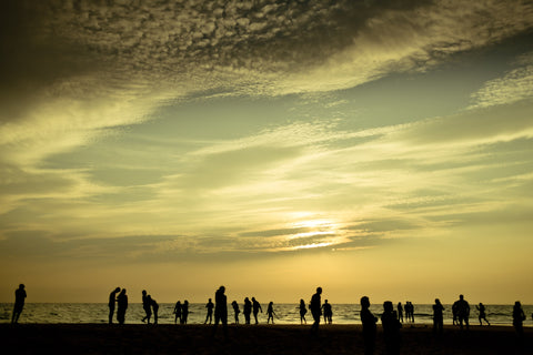 Climate change effects / hottest temperatures / People on beach on hot day / Photo by Raimond Klavins on Unsplash