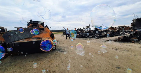 Kyiv Oblast Bucha, Ukrainian Bubble Artists from Duo Magic make Bubbles over burnt out Russian Tanks that have been abandoned May 2022