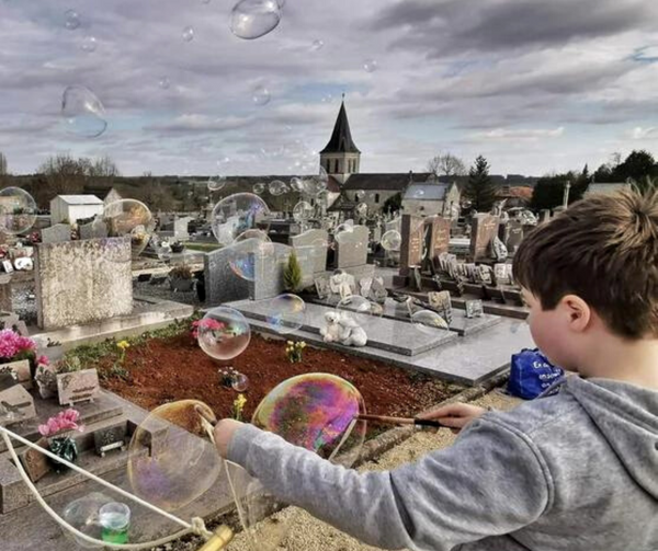 Boy making bubbles at the cemetery