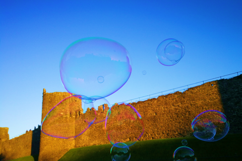 Conwy Castle and giant bubble, setting sun, blue skies, taken at Conwy Food Festival