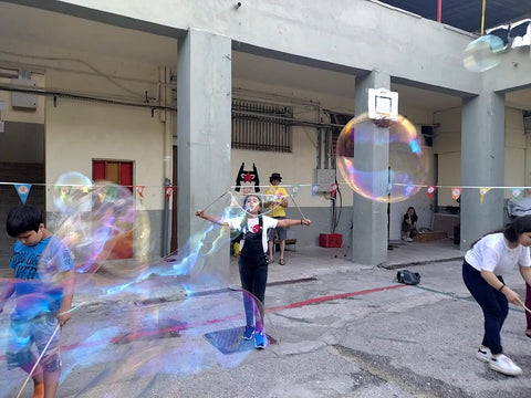 Kurdish Yazidi and Afghan girls and children playing with Dr Zigs Eco Bubbles in a Refugee Camp