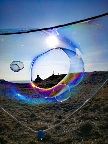 Ynys Llandwyn – Llandwyn Island image, view of Celtic cross and lighthouse in a multicoloured giant bubble