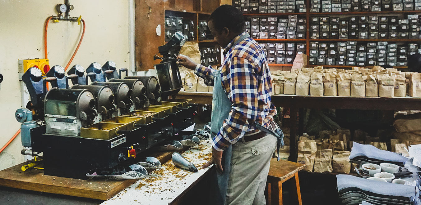 Image of a man in Kenya organizing coffee beans.