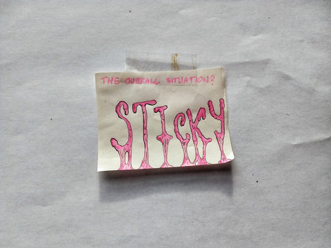 Post-it note with the words sticky artfully rendered in pen and pink ink.