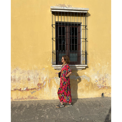 walking-the-streets-pink-ikat-dress-yellow-building