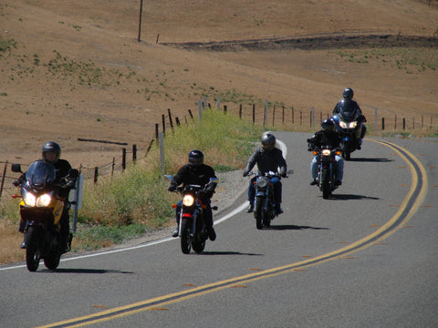 group of motorcycle riders on the road