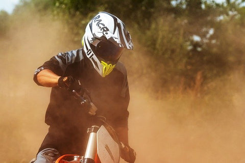 Motorcycle riding with dust in the air