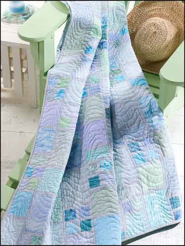 A blue block quilt draped over a deck chair