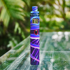 Purple and blue pattern vape on glass table outside.