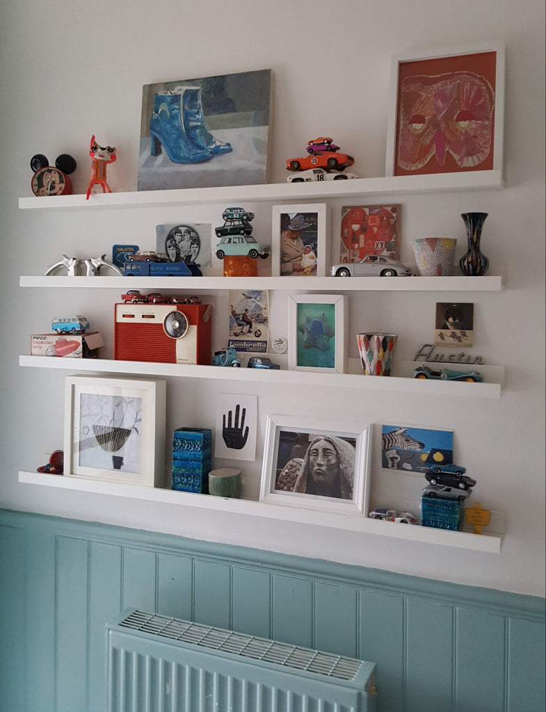 Small objects arranged on white shelves
