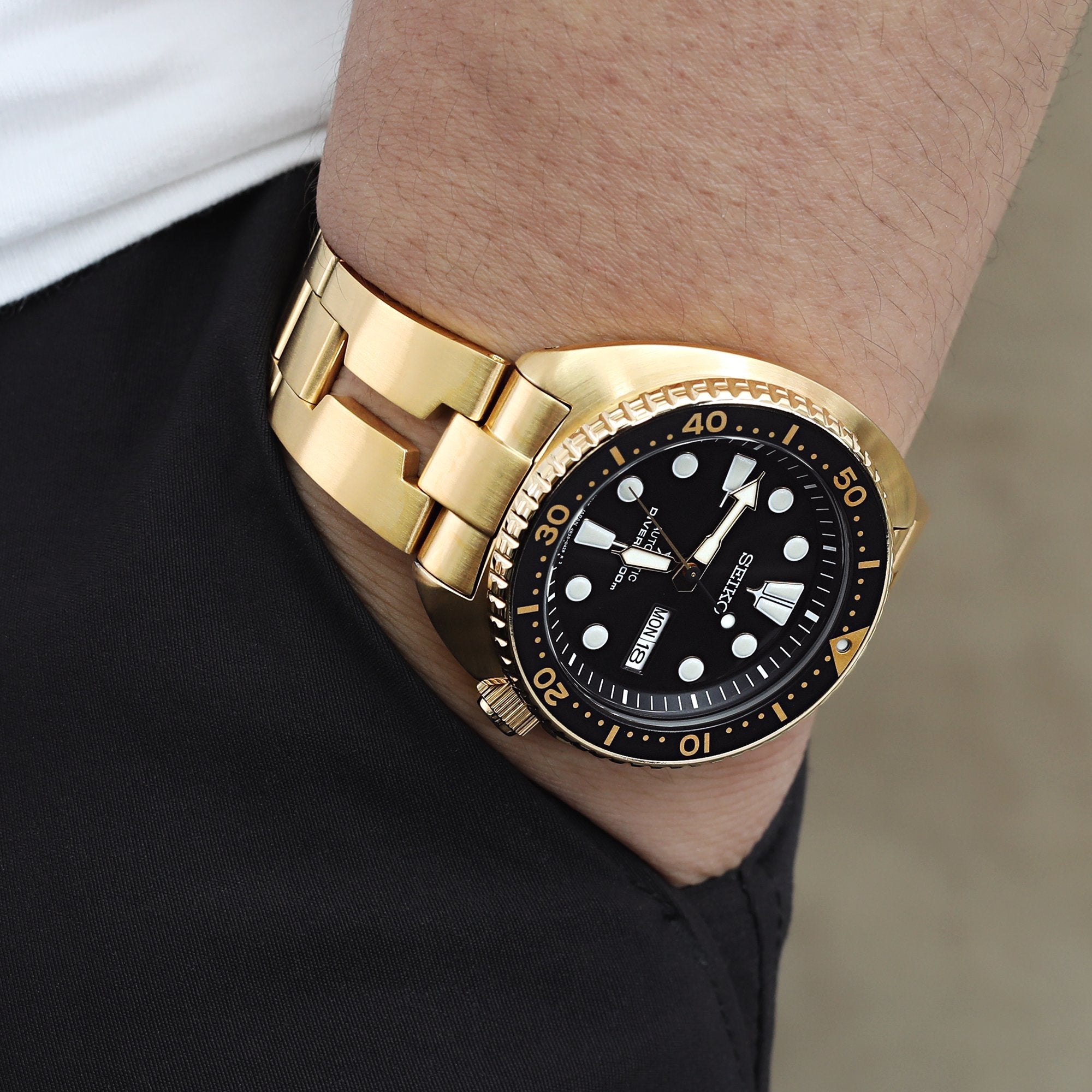 The Seiko Gold Turtle SRPC44 watch paired with a matching gold-tone Razor watch band by Strapcode 