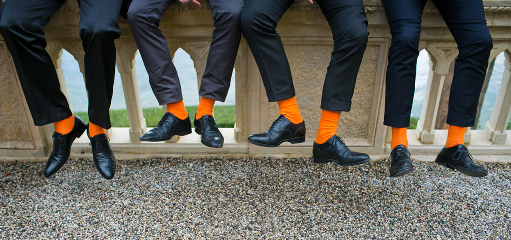 Groomsmen wearing colorful orange socks