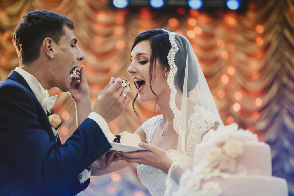 A couple eating wedding cake