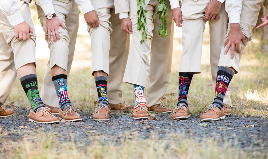 Groomsmen wearing superhero socks