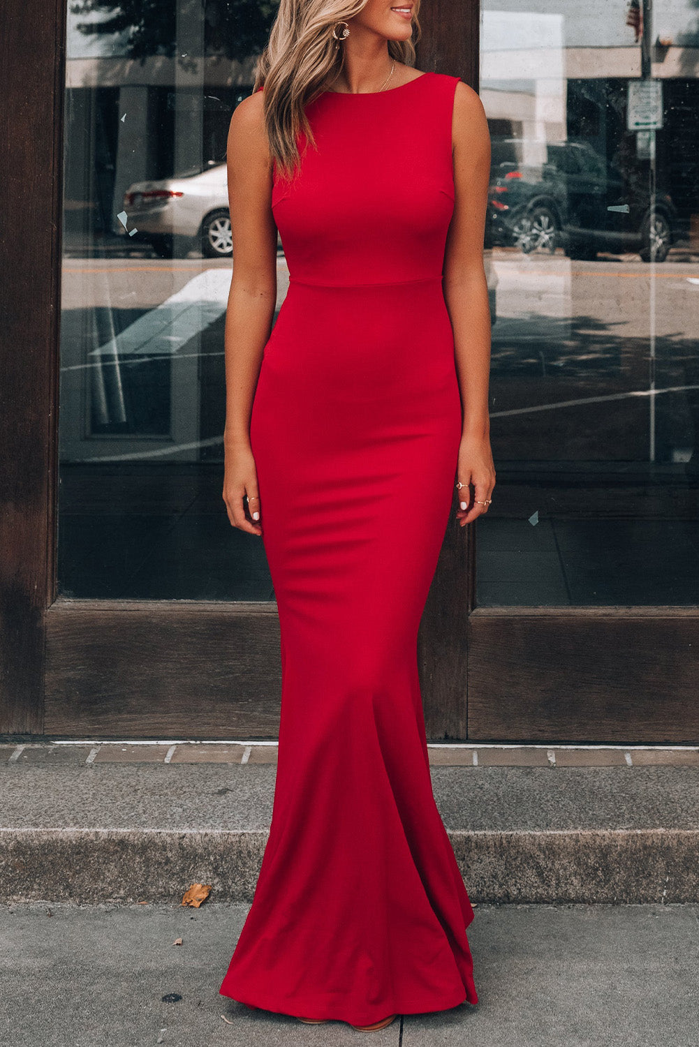 A woman wearing the Bow Knot Ruffled Backless Sleeveless Gown.