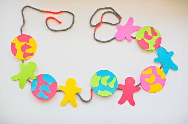 Earth Day Craft colorful earth and people paper garland with link to recipe 