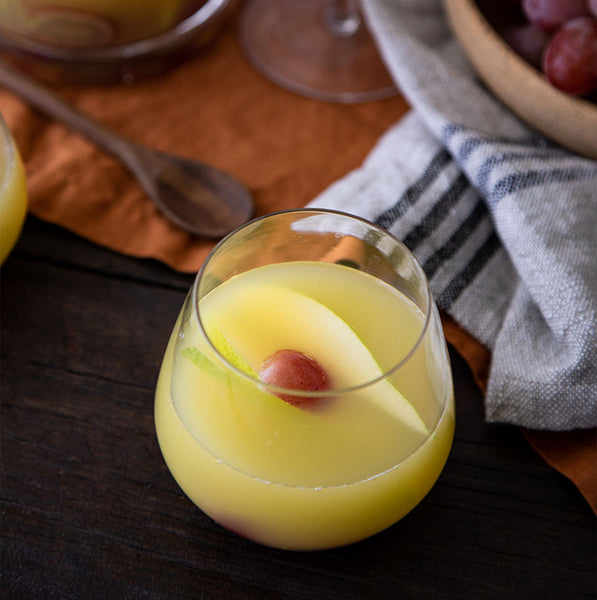 Brunch Sangria cocktail with grapes and pears and dish towels in the background with link to recipe